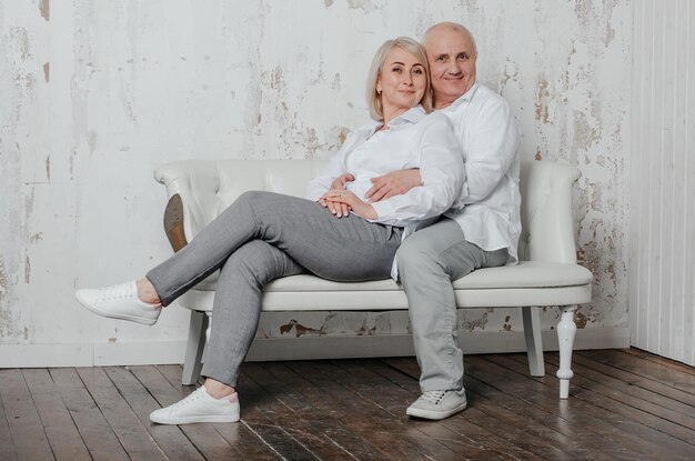 Een man en zijn vrouw in witte overhemden in een fotostudio