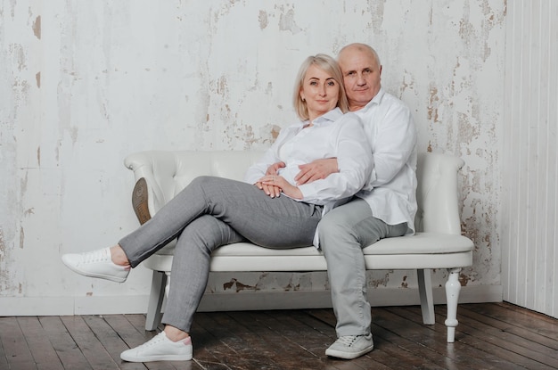 een man en zijn vrouw in witte overhemden op de bank