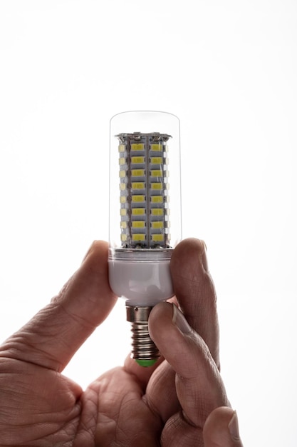 Een man houdt een LED-lamp vast. Energiezuinige LED-lamp.