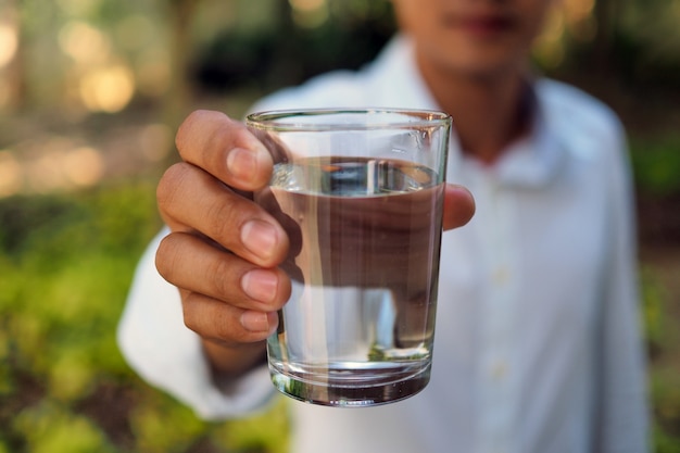 Een man houdt water te drinken.