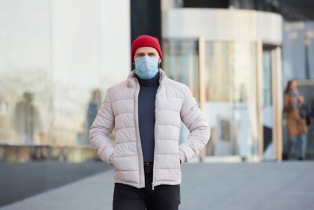 Een man met een gezichtsmasker op het gezicht vanwege de pandemie die op straat loopt