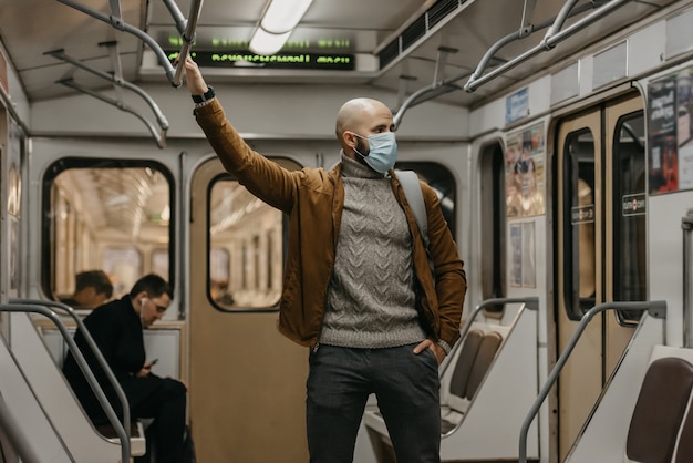 Een man met een medisch gezichtsmasker bij het metrostation