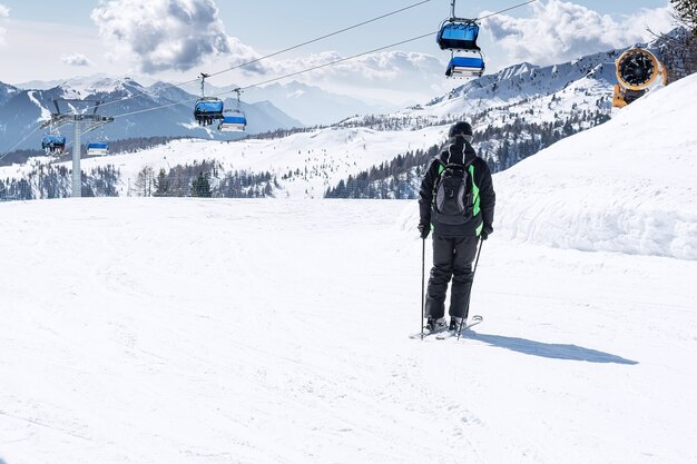 Een man rijdt de skipiste af