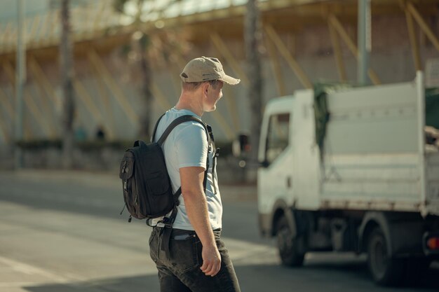Een man toerist met een rugzak loopt door de stad