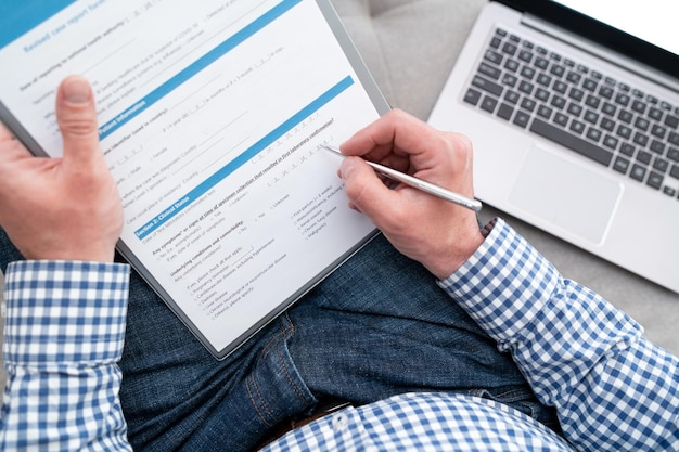 Foto een man vult een medisch formulier in voor een coronavirus-test die hij in quarantaine bevindt