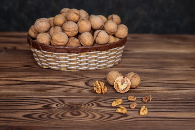 Een mand vol walnoten op een houten achtergrond