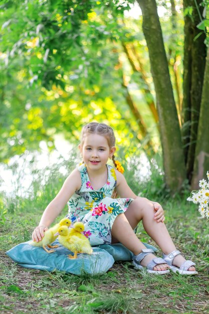 Een meisje en een eendje in de zomer buiten Gute baby's Geluk