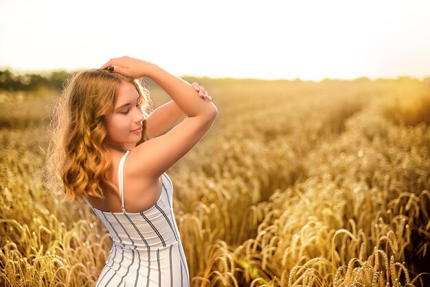 Een meisje in het wit in een tarweveld Zomertijd