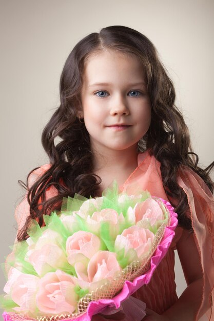Een mooi jong meisje met een boeket papieren tulpen.