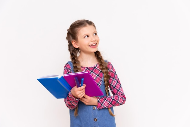 Een mooi meisje met boeken op een witte geïsoleerde achtergrond onderwijs voor kinderen