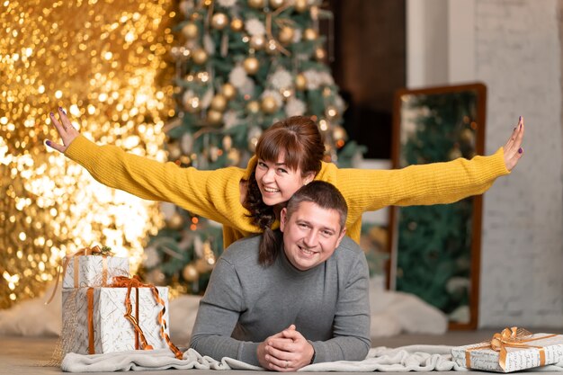 Een mooi vrolijk stel begroet de kerstvakantie in een gezellige huiselijke sfeer.