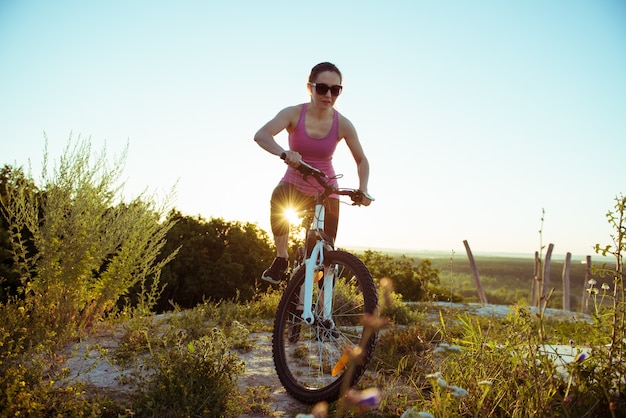 Een mooie jonge vrouw rijdt op een fiets op de dag van de natuur