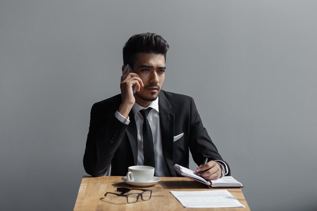 Een mooie succesvolle man praten op telefoonkantoor in café