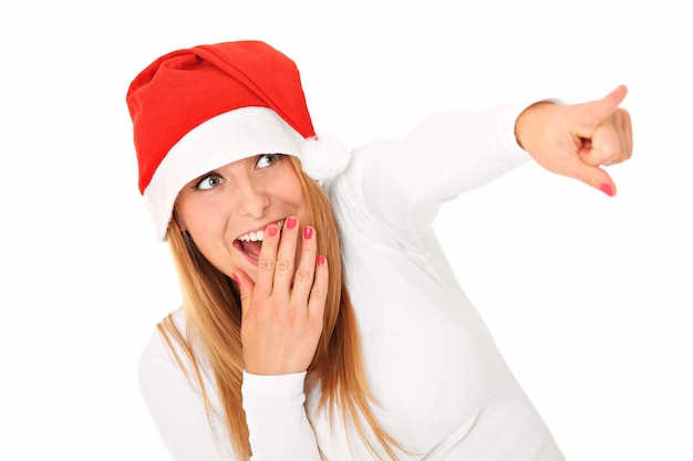 een mooie vrouw in de hoed van de kerstman wijzend op iets over wit