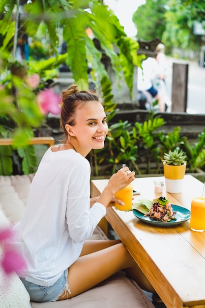 Een mooie vrouw ontbeet in een stijlvol café