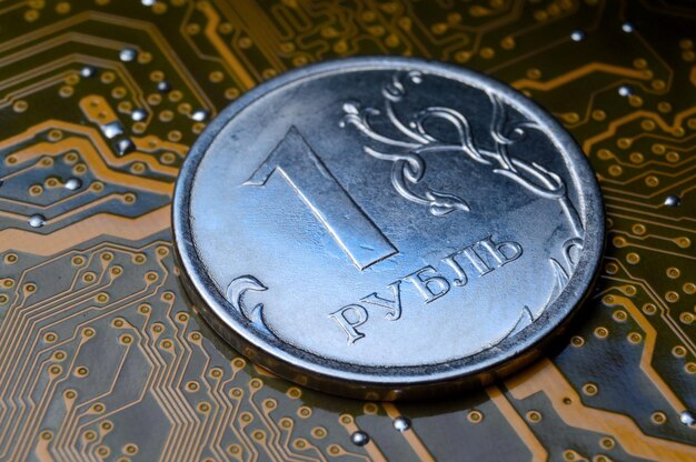 Een munt met een nominale waarde van 1 roebel ligt op een close-up van een microcircuit Vertaling van de inscriptie op de munt quot1 roebel Het concept van de digitale economie in de Russische Federatie