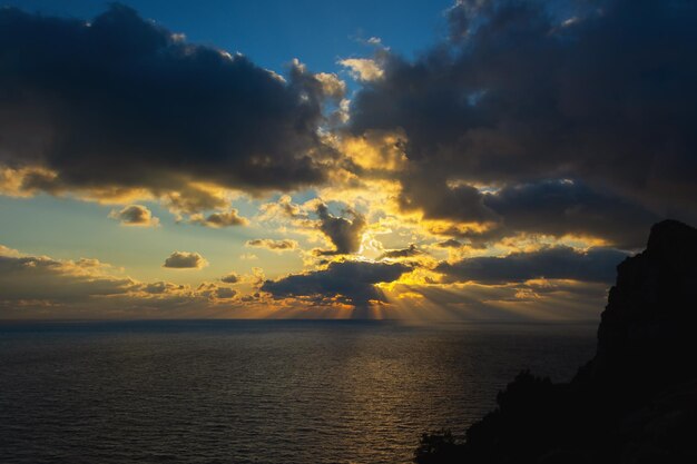 Een onweerswolk in het oranjegele licht van de zonsondergang