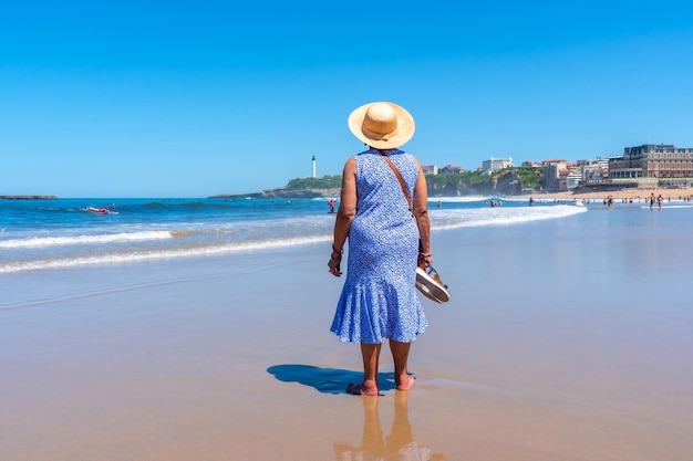 Een oudere vrouw die op het strand loopt in de badplaats Biarritz Lapurdi France South West