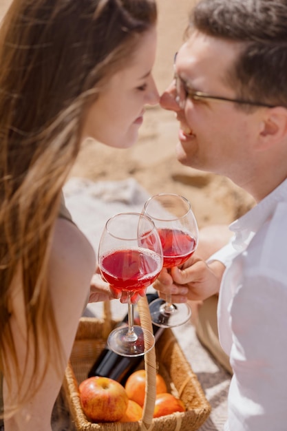 Een paar man en een vrouw lopen langs het strand en picknicken op het zand op