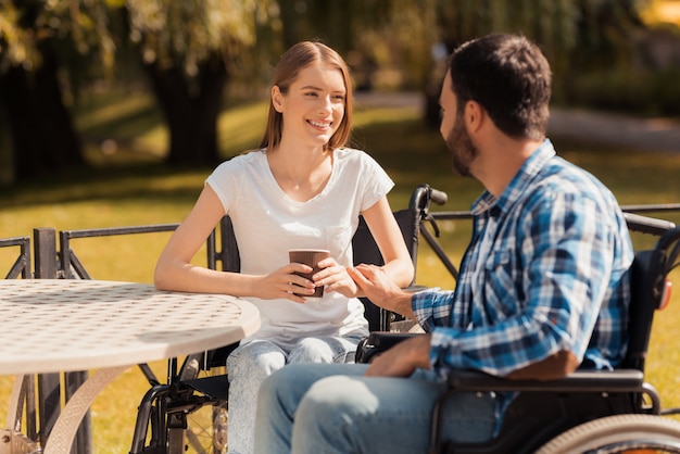 Foto een paar mensen met een handicap drinken koffie.