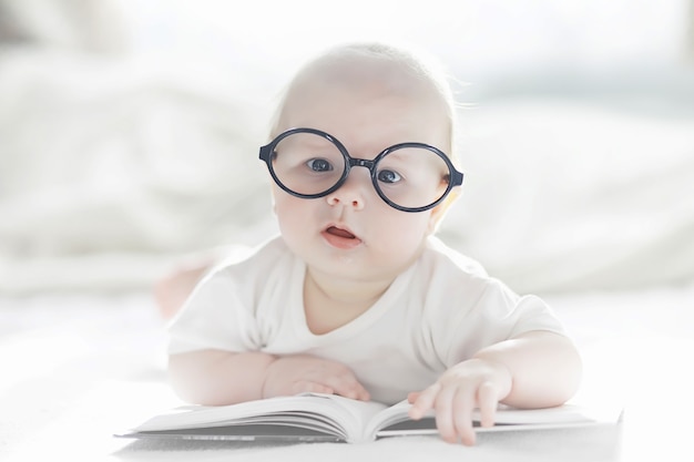 Een pasgeboren baby ligt op een zacht bed. Emoties voor kinderen.