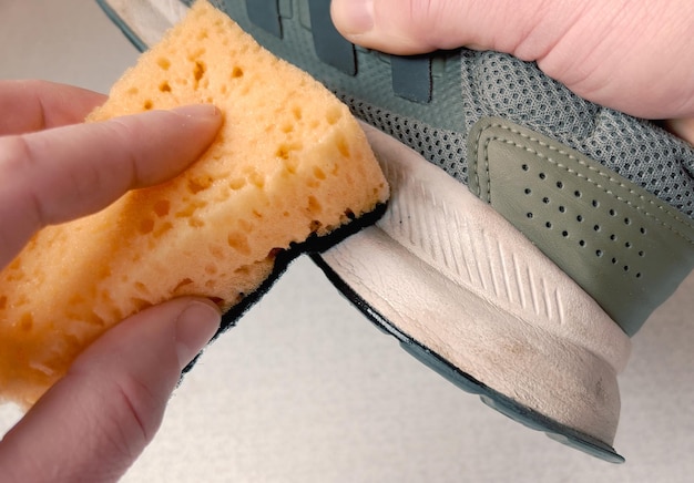 Foto een persoon die een schoen schoonmaakt met een spons
