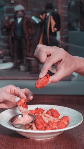 een persoon die voedsel eet met een vork en een bord voedsel