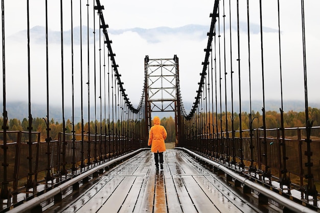 één persoon op de brug vanuit het achteraanzicht, reisavontuur, hangbrug