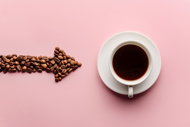 Een pijl met koffiebonen geeft een kopje koffie in de buurt aan. Koffie liefde concept.