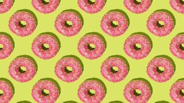 Een prachtig patroon van roze donuts op een groene achtergrond