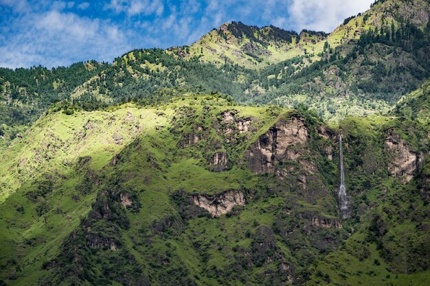Een schilderachtig uitzicht op een mosrijke berg tegen een bewolkte lucht