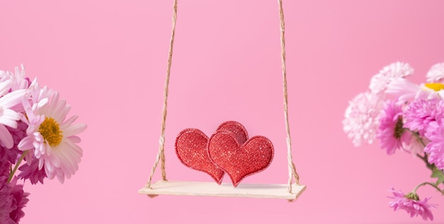 Een schommel met twee harten op roze achtergrond Creatieve banner voor Happy Valentines Day