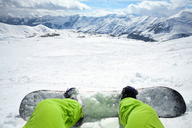 Een snowboarder met snowboard op de bergtop van de winter