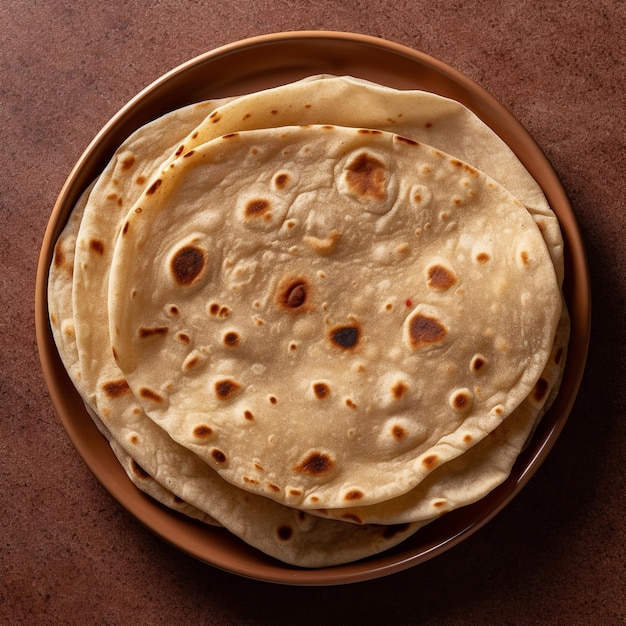 Een stapel roti chapati geïsoleerd op een houten mand en een houten achtergrond