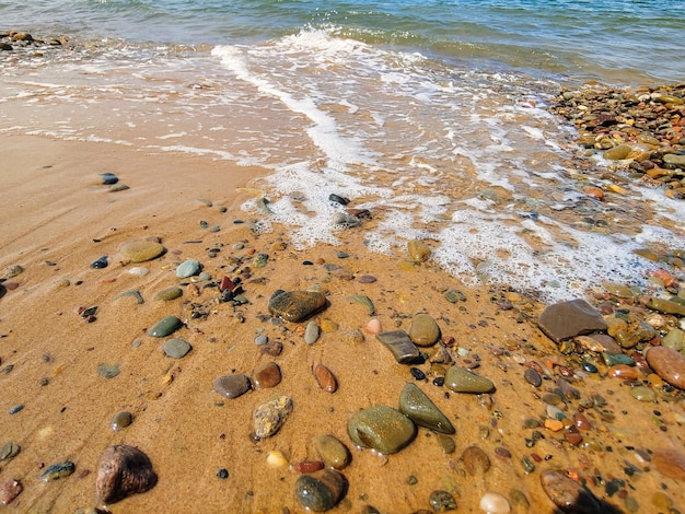 een strand met rotsen en water erop