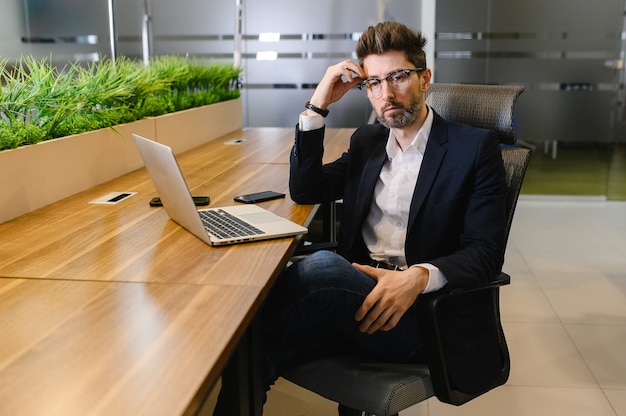 Een succesvolle handelaar analyseert aandelen en de aandelenmarkt met behulp van een laptop en tabletaandelen die de opkomst en ondergang van de aandelenmarkt verhandelen