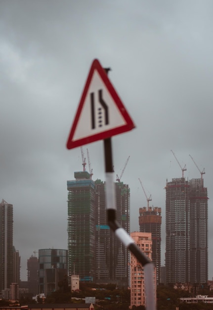 Een verkeersbord bij gebouwen tegen de lucht in de stad