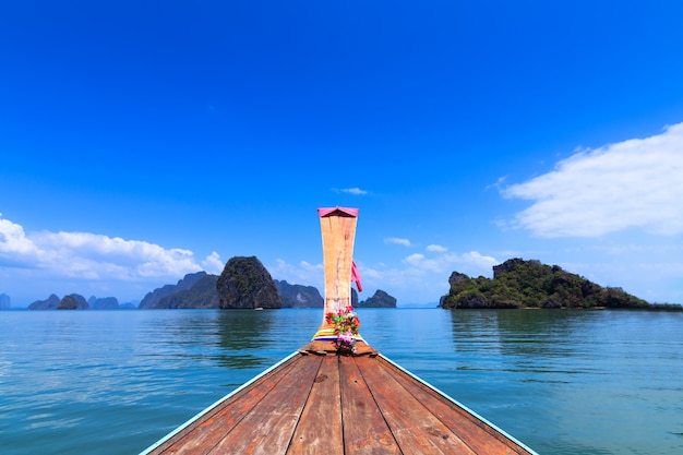 Foto een voorzijde van lange staartboot en mening van phuket-overzees in thailand. adaman zee en houten boot
