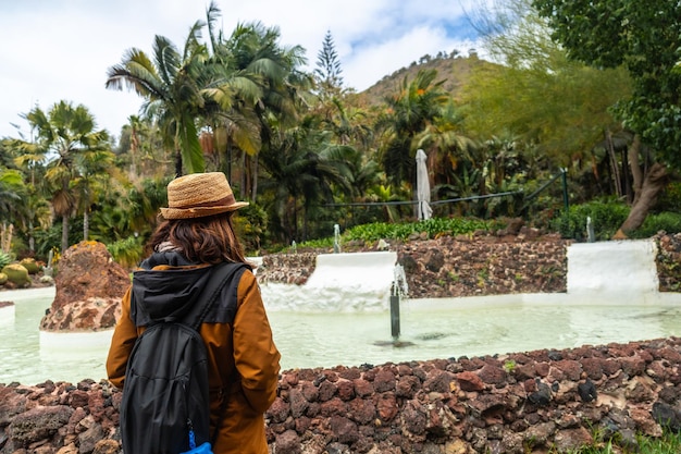 Een vrouw die geniet en wandelt in een tropische botanische tuin