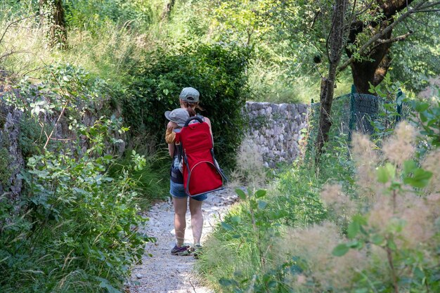 Een vrouw en een kind lopen over een pad in het bos.