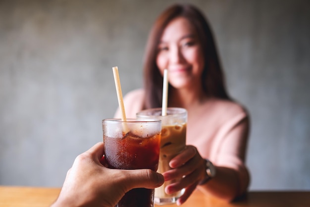 Foto een vrouw en een man rammelende koffieglazen samen in café