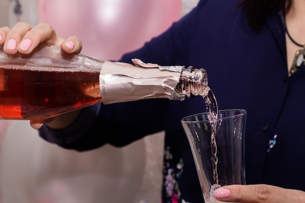 Een vrouw schenkt champagne in een glas