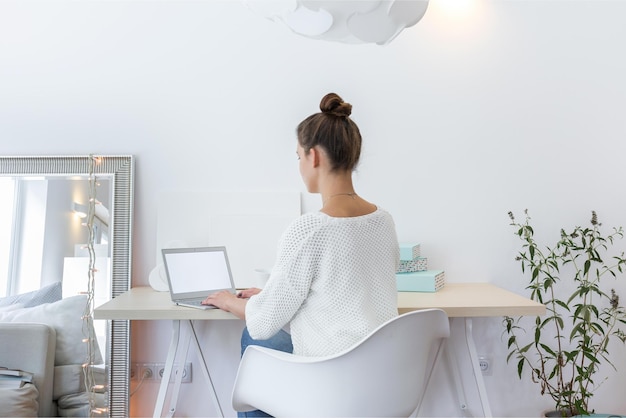 Een vrouw zit aan een bureau voor een fotolijst waarop staat 'ik ben freelancer'