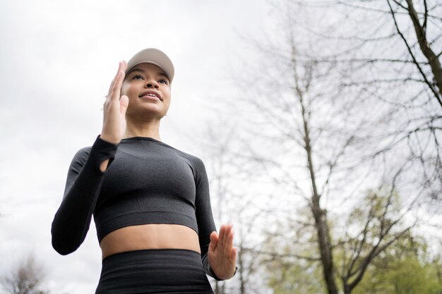 Een vrouwelijke atleet die hardloopt, traint op straat in sportkleding en een fitnesshorloge aan haar hand