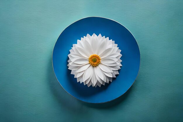 Foto een witte bloem in een blauwe kom op een blauwe achtergrond
