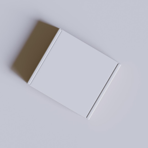 een witte doos met een gouden band ligt op een wit oppervlak