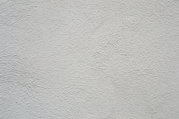 Een witte muur met een ruw gestructureerd oppervlak.