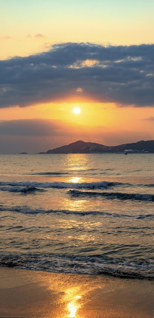 Een zonsondergang boven de zee met de ondergaande zon boven de horizon.
