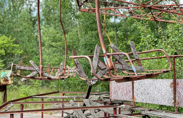 Eerie scene of an abandoned amusement park a rusting merrygoround overtaken by nature
