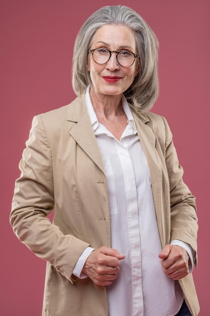 Effective mature woman in beige jacket